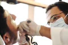 A dentist performing dental services on a patient